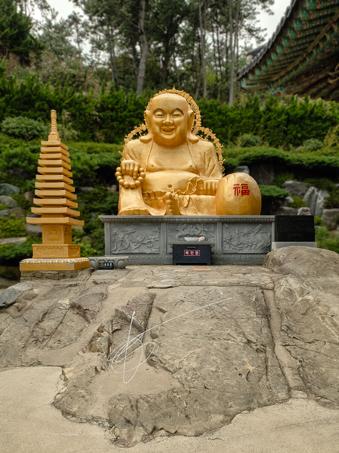 A golden statue of Buddha in the coastline temple of Busan