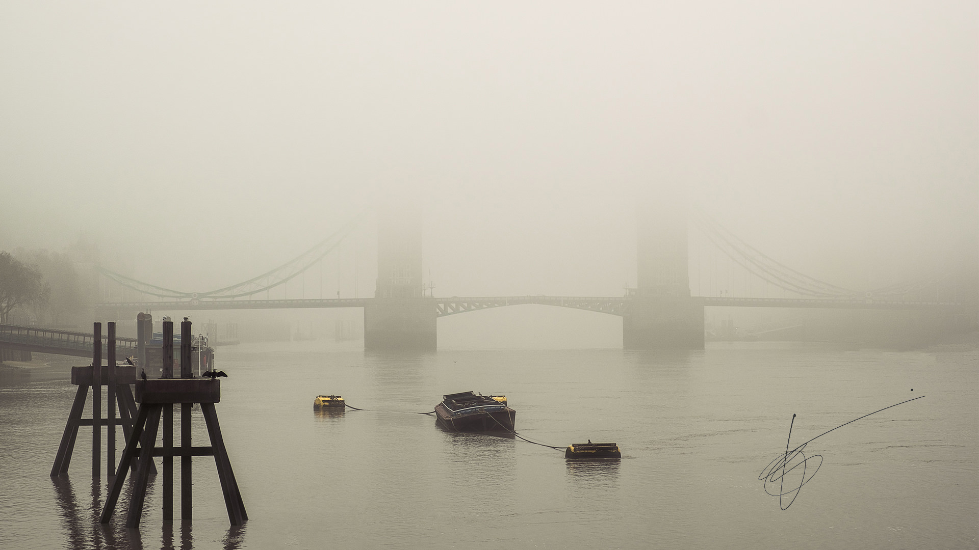 Tower Bridge in London almost invisible behind a thick fog layer