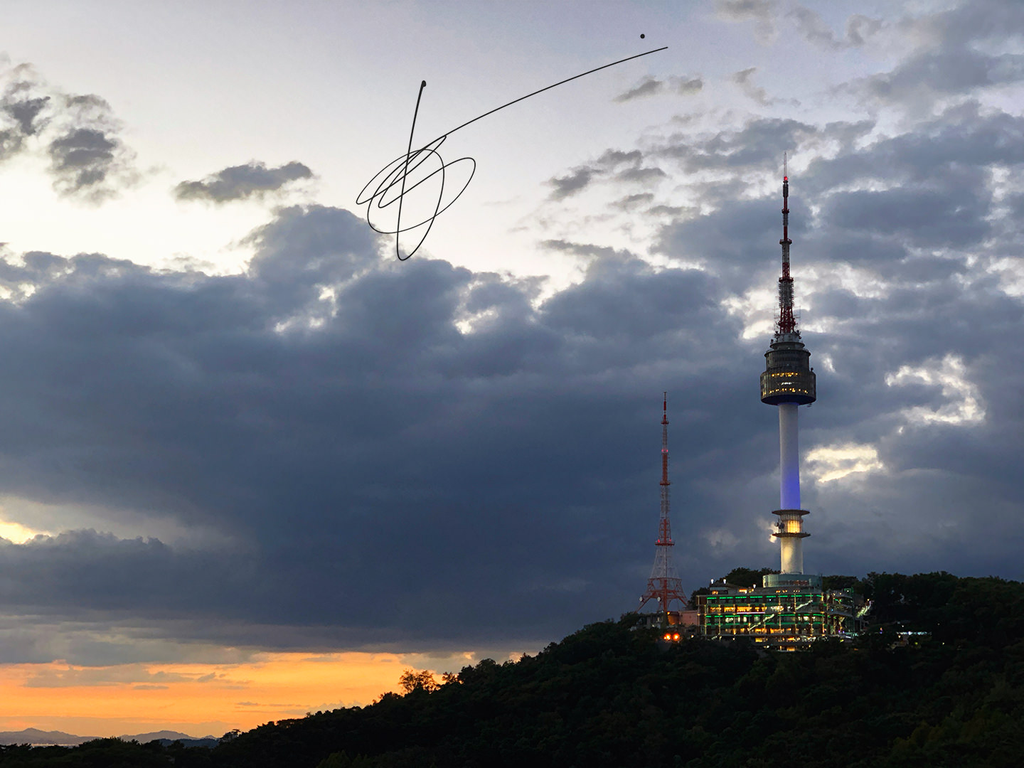 N Seoul Tower on top of the hill at sunset